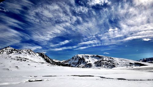 Scenic view of snowcapped mountains against sky