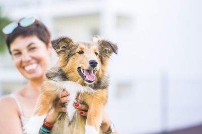 Happy woman with dog outdoors