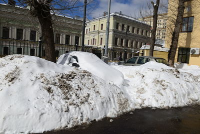 Snow covered buildings in city