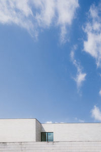 Low angle view of building against cloudy sky