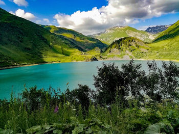 Scenic view of lake and mountains against sky