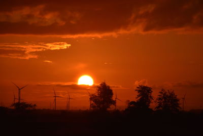 Silhouette trees against sky during sunset