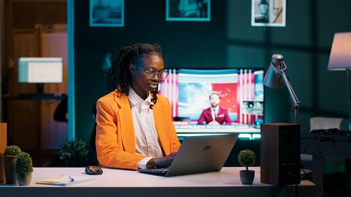 Businesswoman using laptop at office