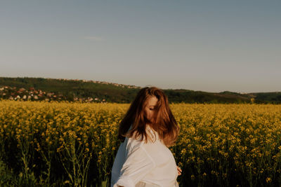 Scenic view of oilseed rape field against sky