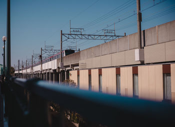 Low angle view of train on railway bridge against clear sky