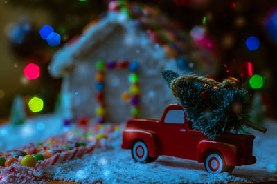 Close-up of gingerbread house with christmas decorations at home