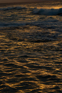 Aerial view of sea against sky during sunset