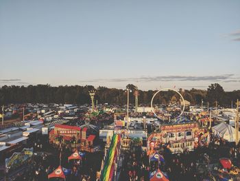 Group of people in amusement park against clear sky