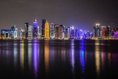 Illuminated city at waterfront