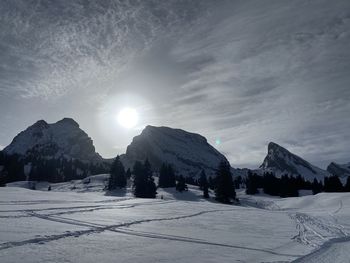 Scenic view of snow covered mountains against sky