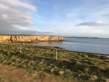 Scenic view of sea and landscape against sky