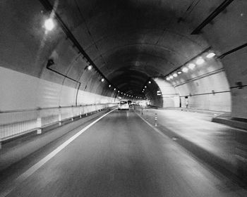 Illuminated tunnel at night