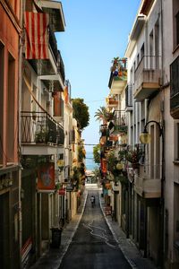 Street amidst residential buildings against sky