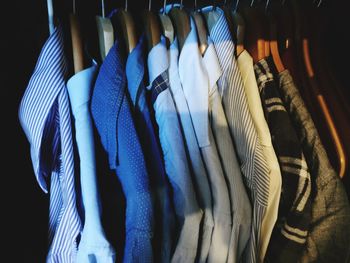 Close-up of clothes hanging on rack in store