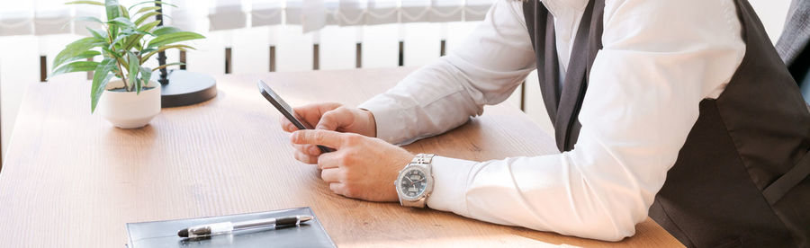 Happy businessman at his desk in office talking on phone. a young businessman