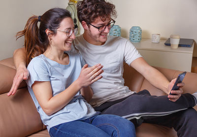 Couple talking on video call while sitting at home