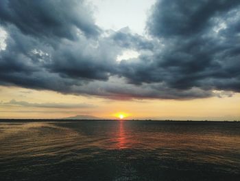 Scenic view of sea against dramatic sky