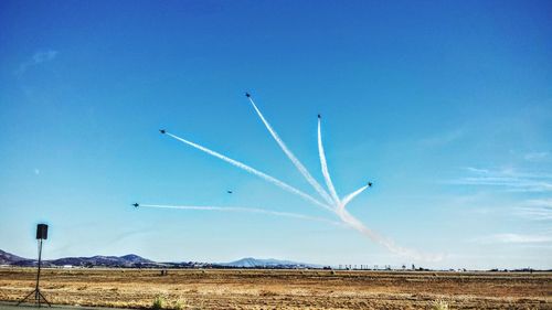 Low angle view of airplane flying against blue sky