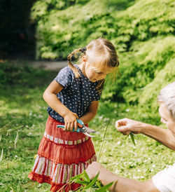 Grandfather and daughter gardening in park