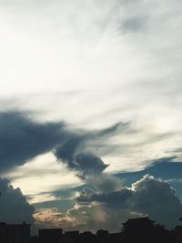 Low angle view of silhouette trees against sky