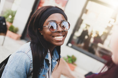 Portrait of smiling young woman wearing sunglasses