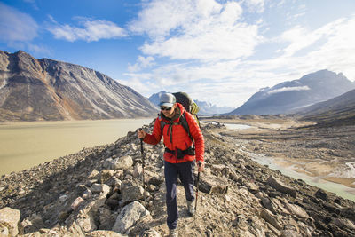 Man standing on mountain against sky