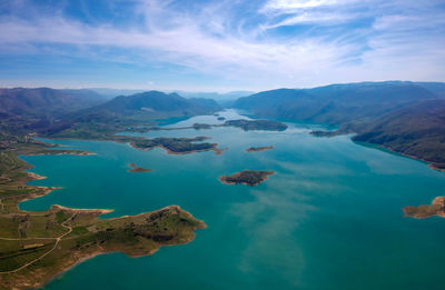 Aerial view of sea against cloudy sky