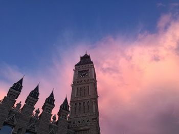 Low angle view of clock tower against sky during sunset