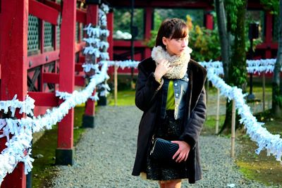 Beautiful woman looking away while standing outdoors