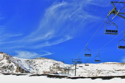 Snow covered mountain against blue sky with empty cable car. stock photo 