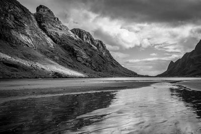 Scenic view of fjord and mountains against sky