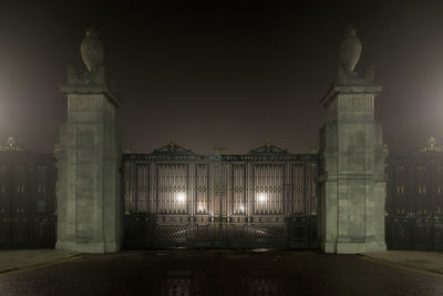 Illuminated building against sky at night