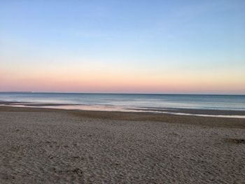 Scenic view of sea against clear sky during sunset