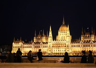 Illuminated building against sky at night