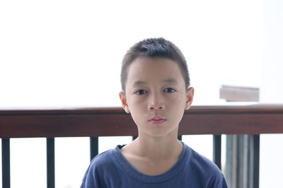 Close-up portrait of boy against clear sky