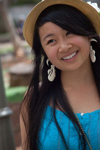 Close-up of smiling young woman looking away