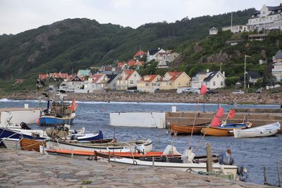 Boats moored at beach against sky