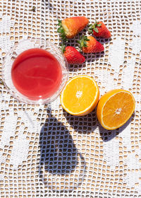 High angle view of orange fruits in glass