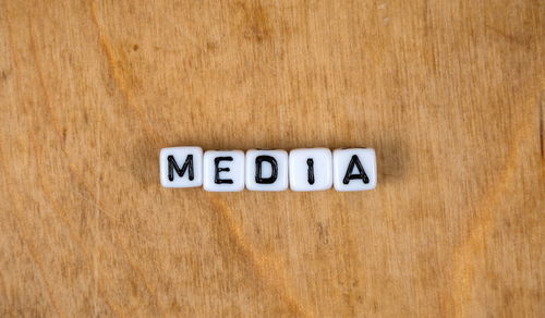 Close-up of warning sign on wooden table