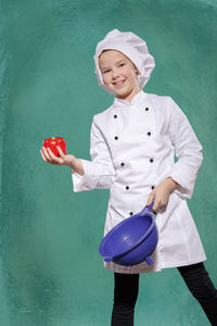 Portrait of smiling girl holding red umbrella