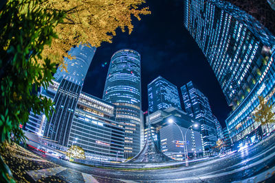 Illuminated modern buildings in city at night