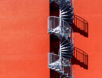 Spiral staircase against orange building