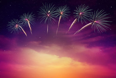 Low angle view of firework display at night
