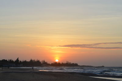 Scenic view of beach against sky during sunset