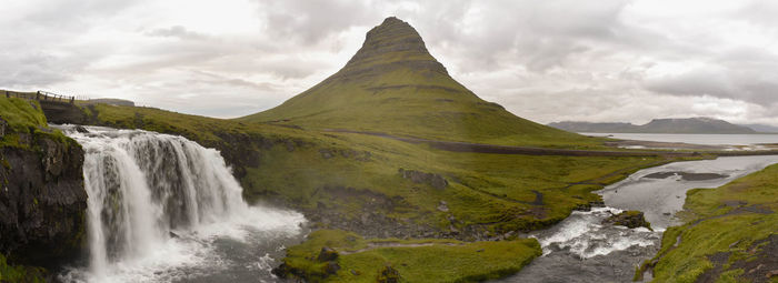 Scenic view of waterfall against sky