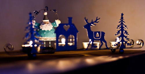 Close-up of illuminated lamp on table