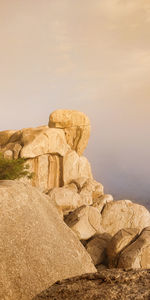 Stack of rocks on shore against sky