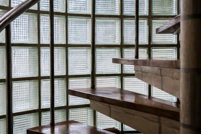 Empty chairs and table by window at home