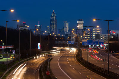 High angle view of light trails on multiple lane highway at night