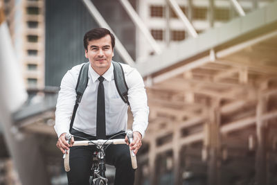 Portrait of smiling man riding bicycle